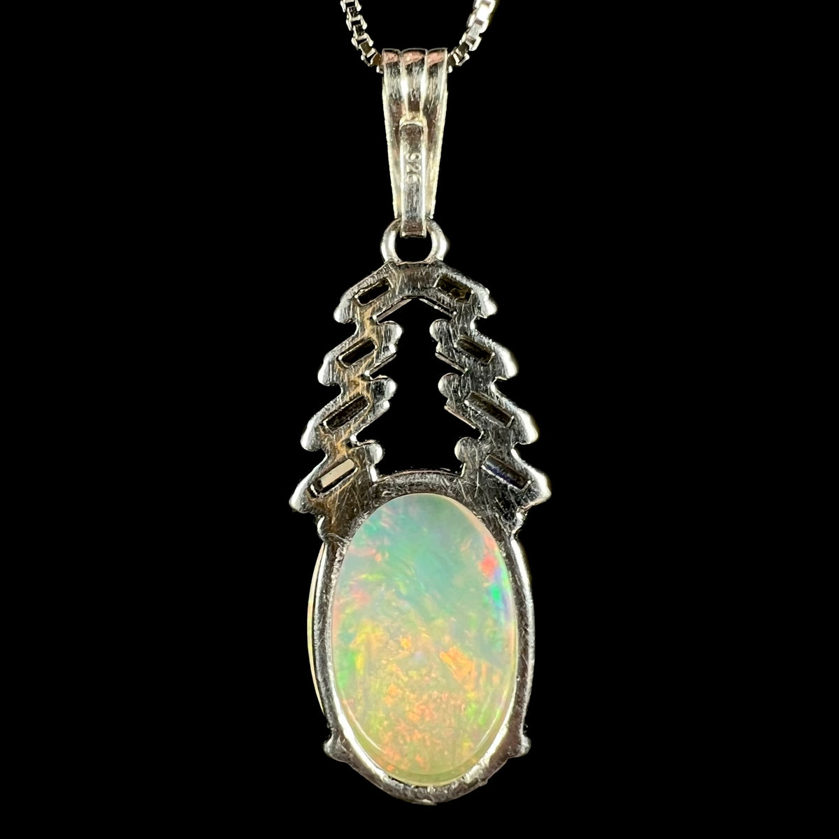 Back side of sterling silver Ethiopian opal drop pendant; "925" hallmark stamp seen on clip-on bail
