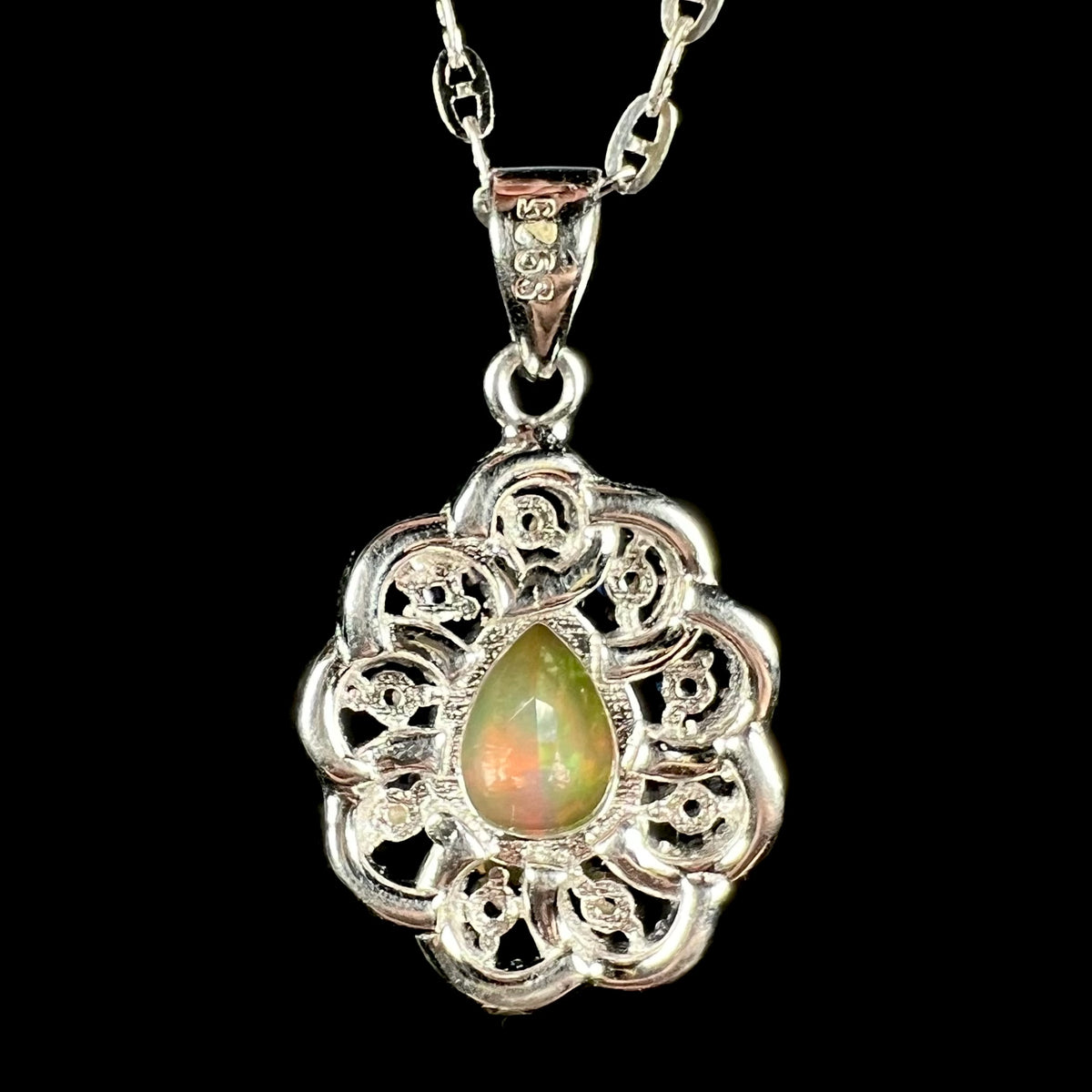 Back side of sterling silver Ethiopian opal pendant showing "S925" hallmark stamp on back of bail