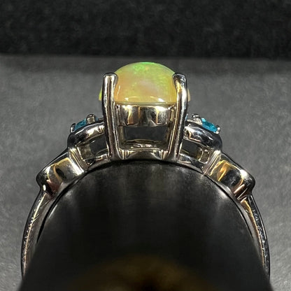 Side gallery profile view of sterling silver Ethiopian opal ring with blue apatite accents on ring display
