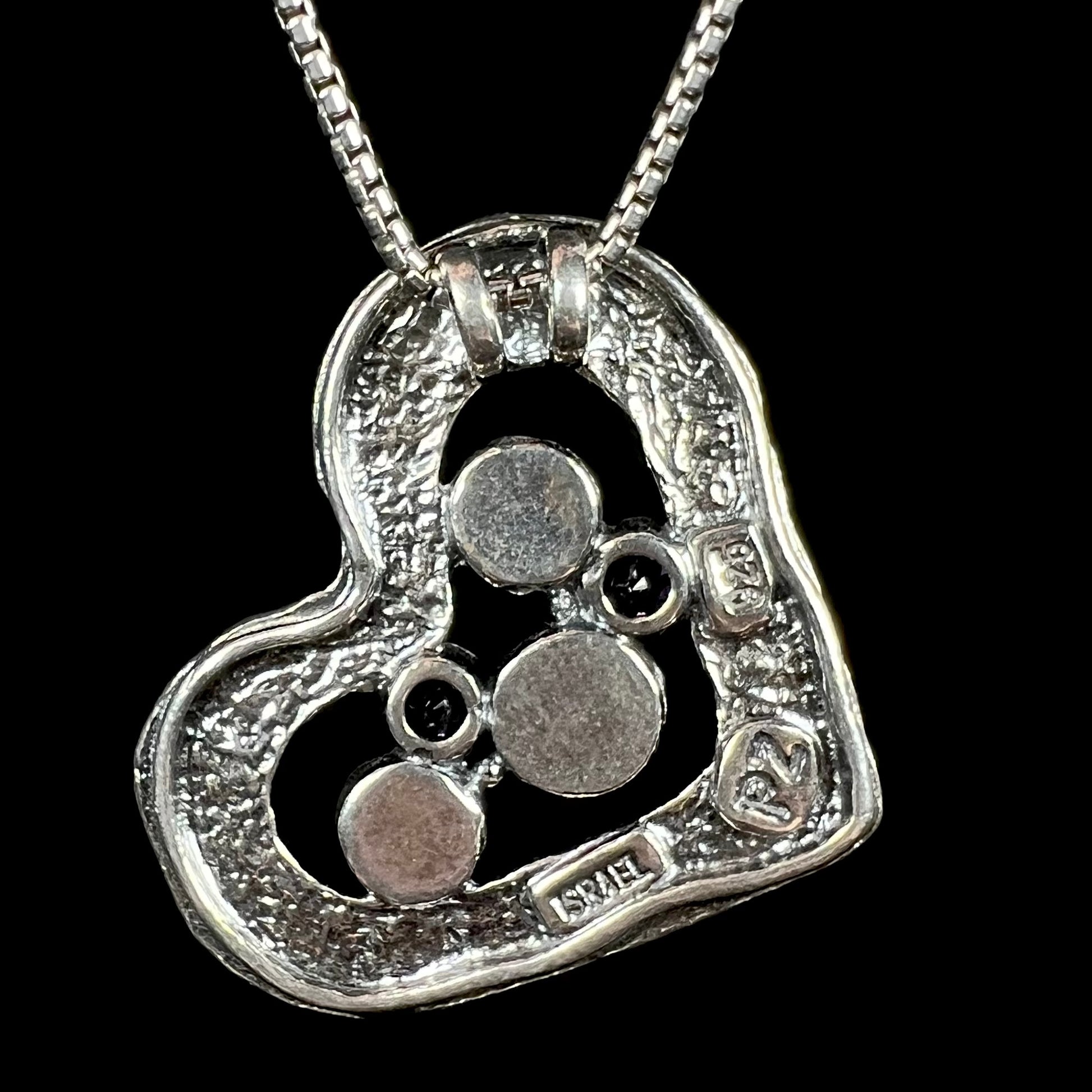 Back side of a multi-gemstone sterling silver heart necklace stamped "ISRAEL", "925", and "PZ".