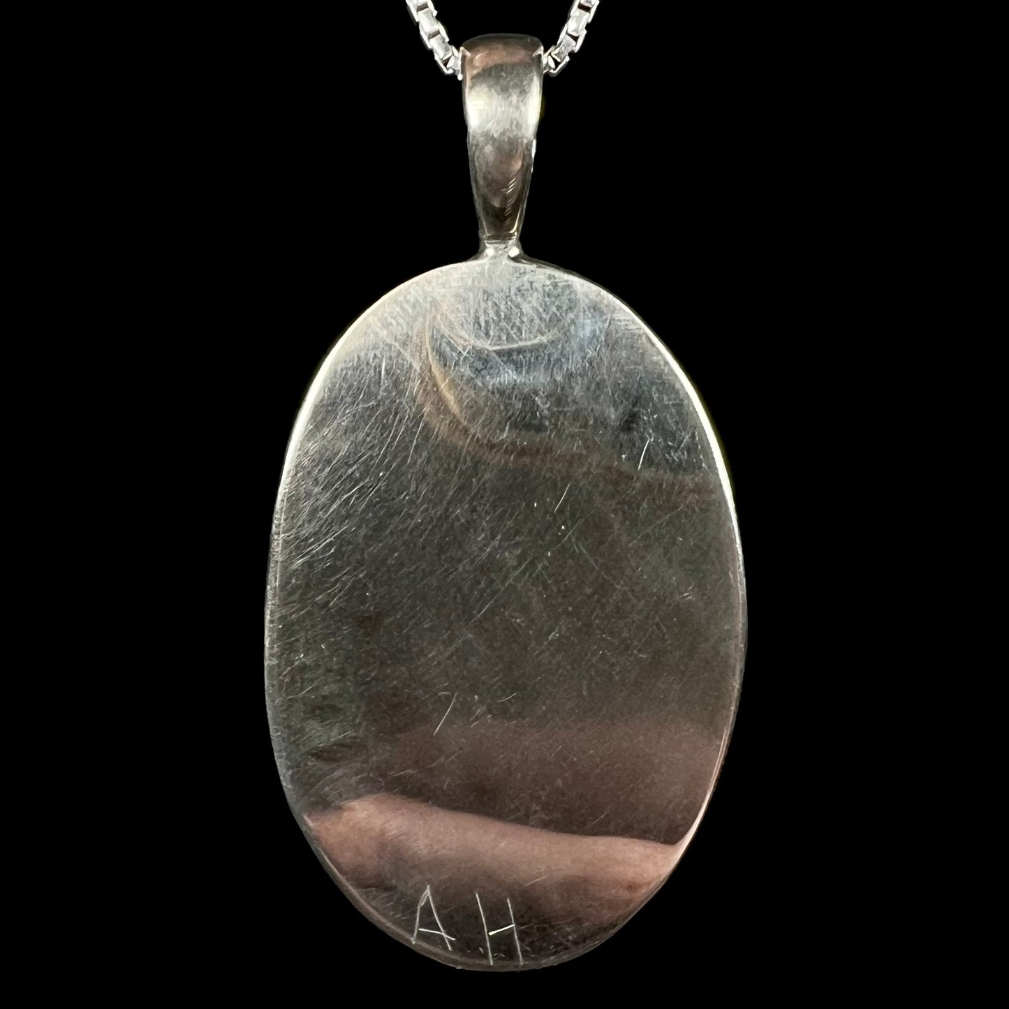 Back side of sterling silver men's pendant signed "AH" by Salt Lake City jeweler, Austin Henderson.