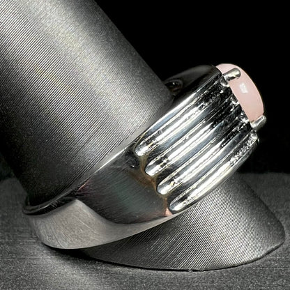 Side view of sterling silver men's ring set with pink Peruvian opal on ring display