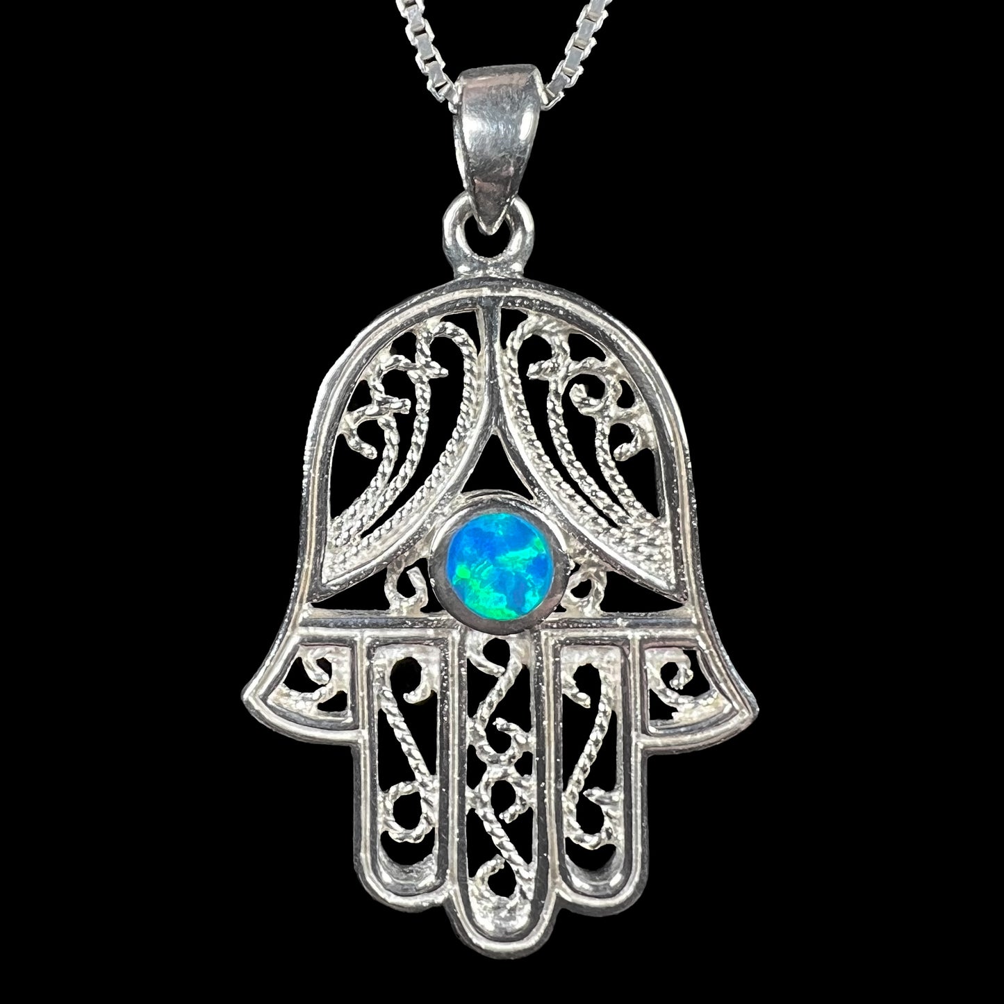 A sterling silver and filigree-accented hamsa hand necklace set with a round lab-created opal.