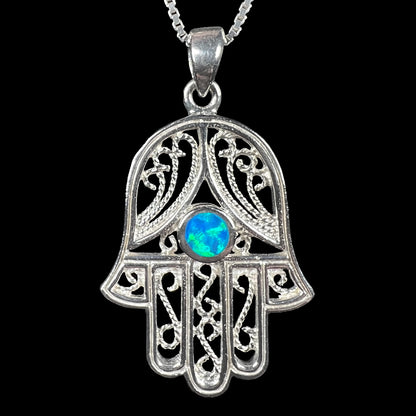 A sterling silver and filigree-accented hamsa hand necklace set with a round lab-created opal.