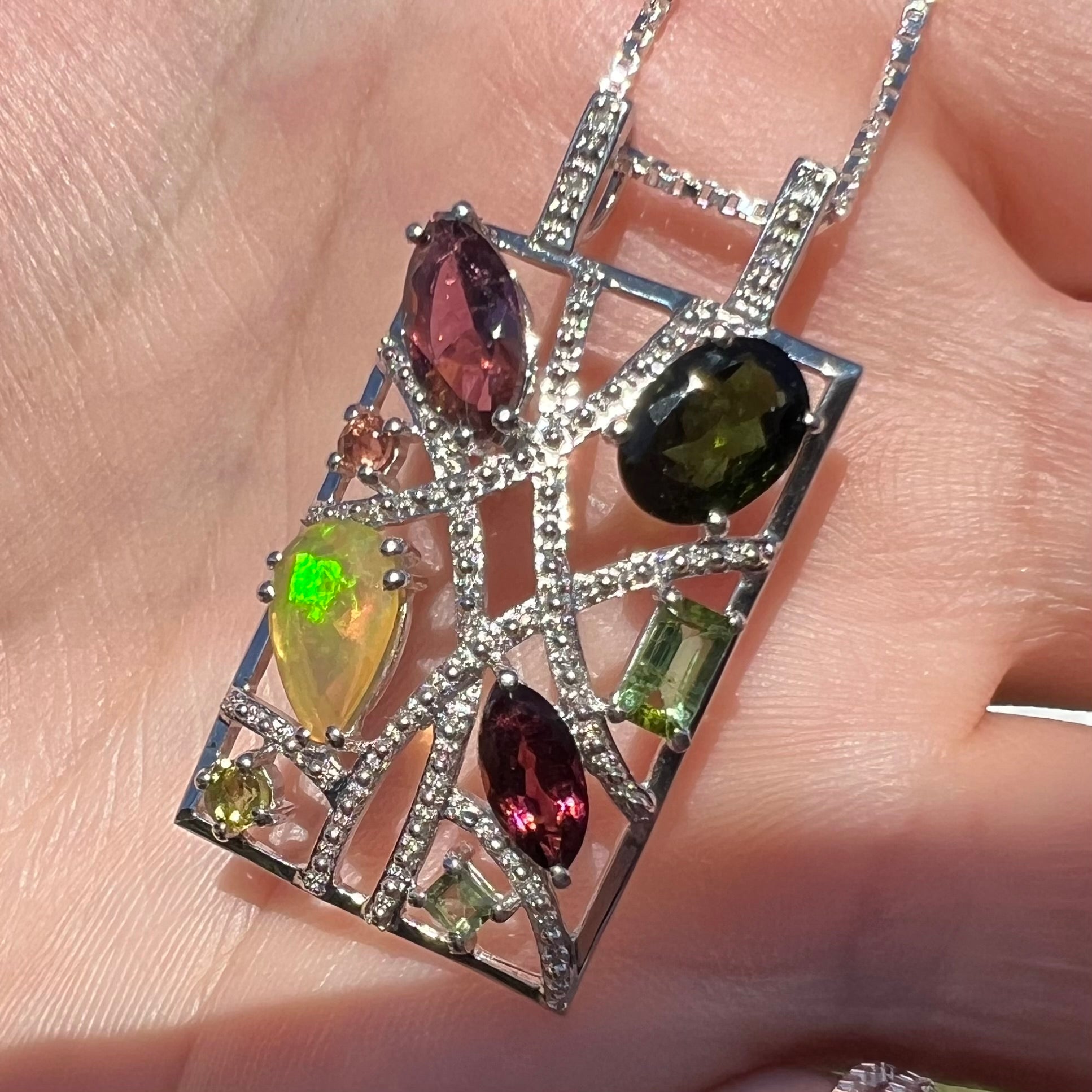 A sterling silver multi-gemstone necklace set with Ethiopian opal, tourmaline, and diamonds.