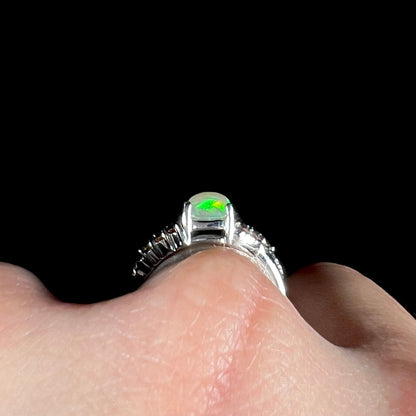 A ladies' silver ring set with a cushion cabochon cut Ethiopian fire opal stone and citrine accents.
