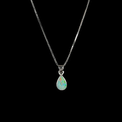 A dainty, sterling silver necklace bezel set with a natural, pear shaped opal stone.