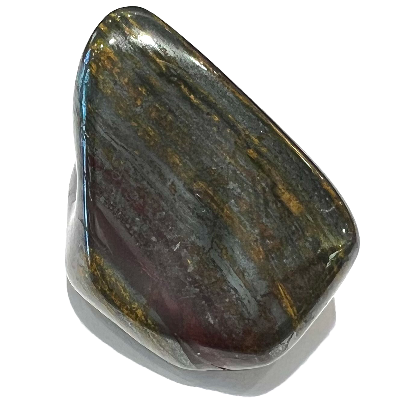 A tumbled Australian tiger iron stone.  Black hematite streaks run through a yellow and red matrix.