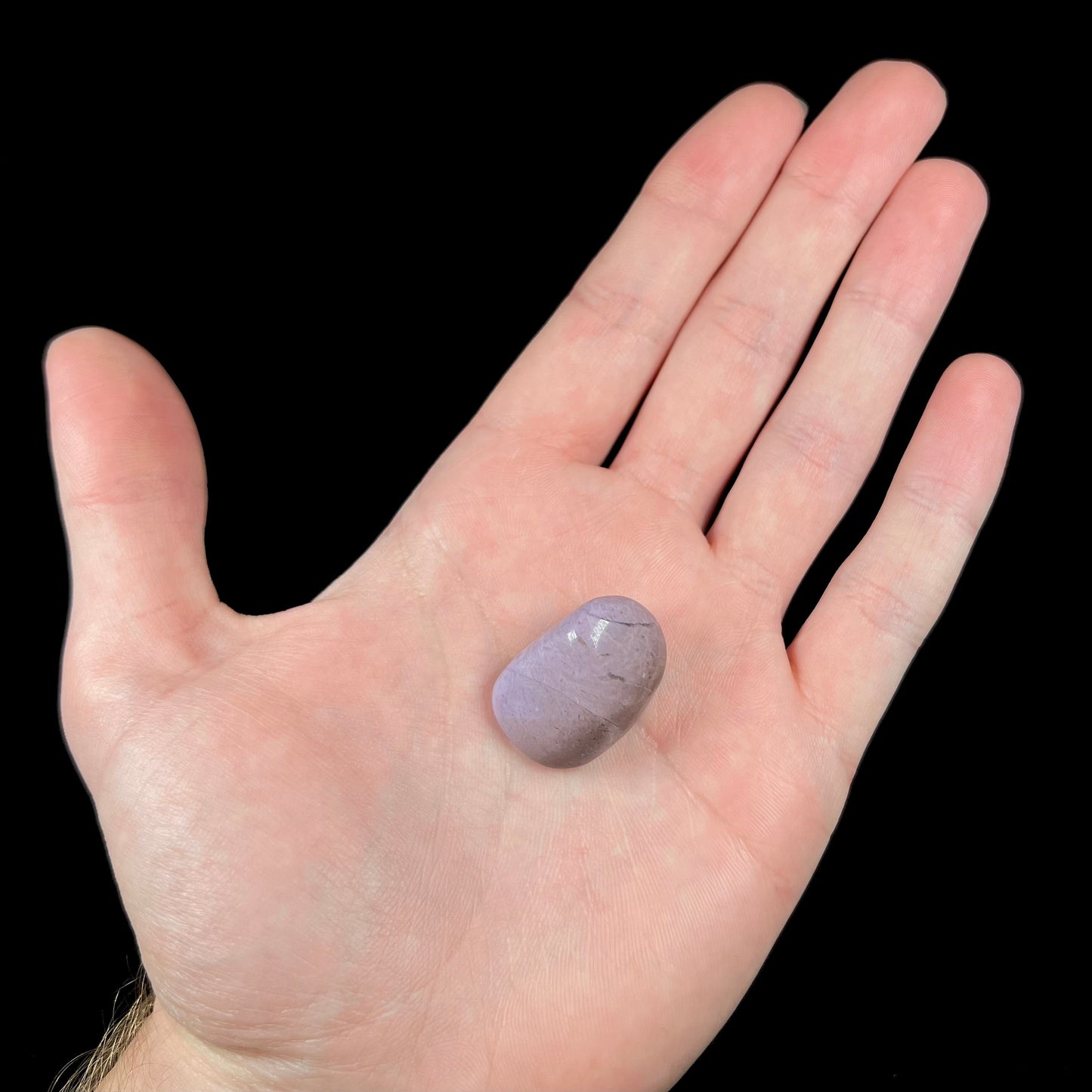 A tumble polished turkiyenite purple jade stone from Bursa, Turkey.