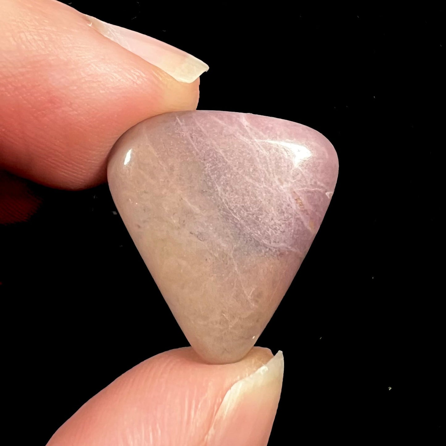 A tumble polished purple and brown turkiyenite jade stone from Bursa, Turkey.