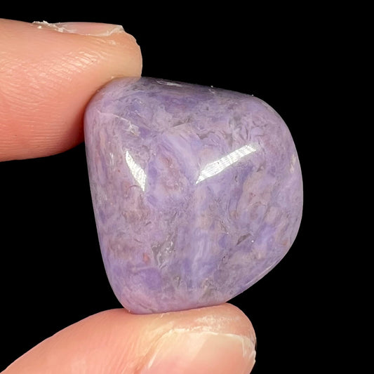 A tumbled Turkish purple jade stone, known as turkiyenite.