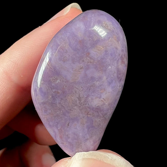 A tumbled purple turkiyenite jade stone.