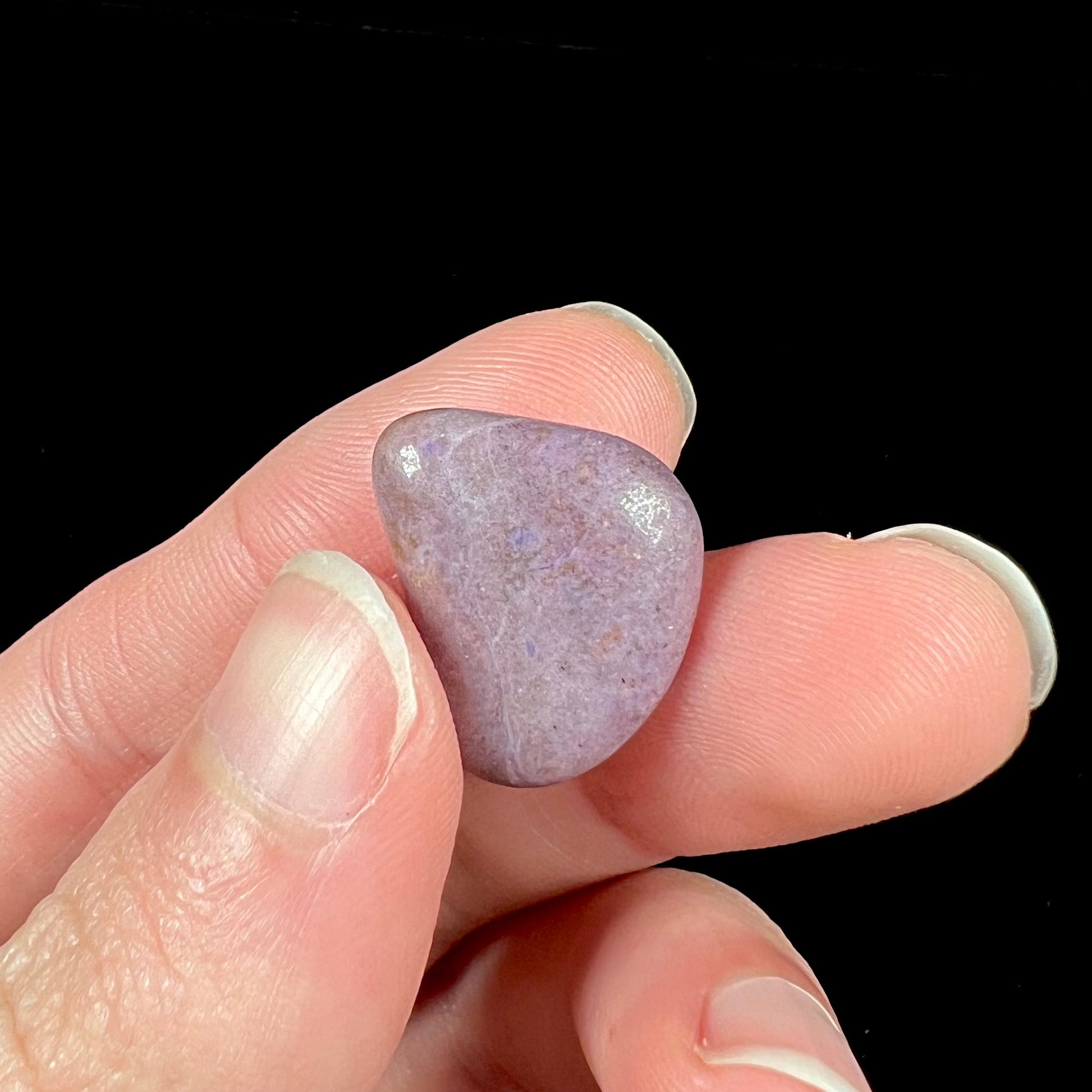 A tumble polished purple turkiyenite jade stone from Bursa, Turkey.