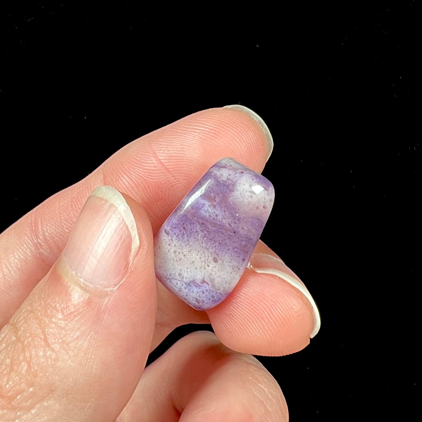 A streaked and spotted purple turkiyenite jade stone from Bursa, Turkey.