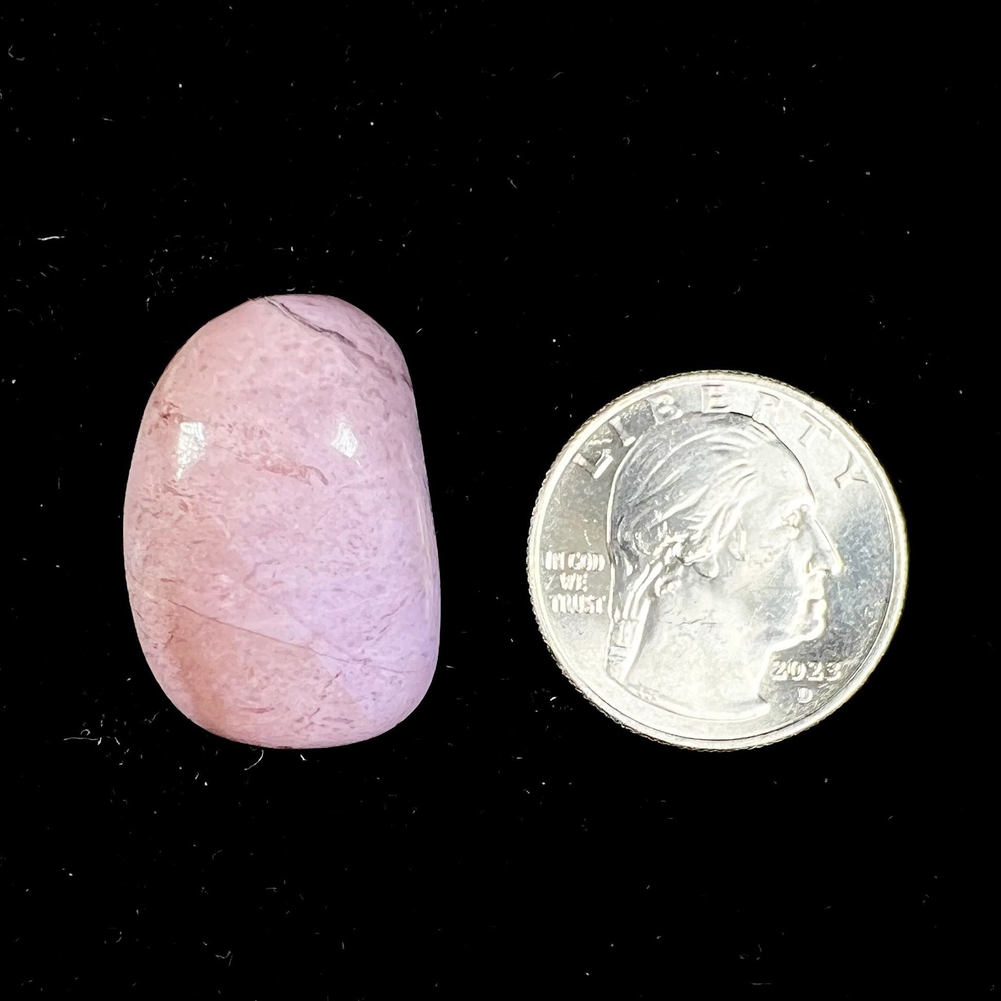 A tumble polished turkiyenite purple jade stone from Bursa, Turkey.