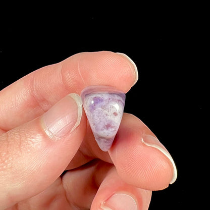 A streaked and spotted purple turkiyenite jade stone from Bursa, Turkey.