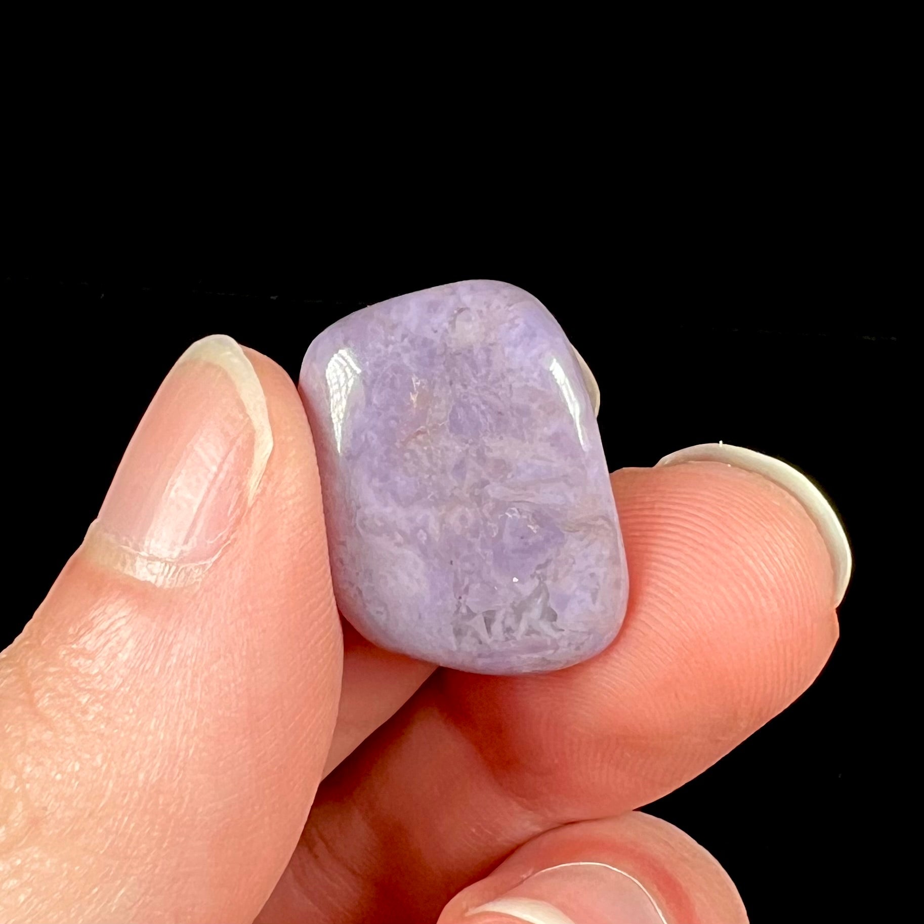 A tumbled Turkish purple jade stone, also known as turkiyenite.