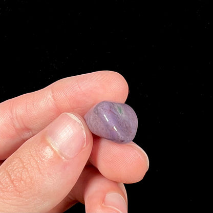 A tumbled purple turkiyenite jade stone from Borsa, Turkey.  The stone has a green jadeite inclusion.