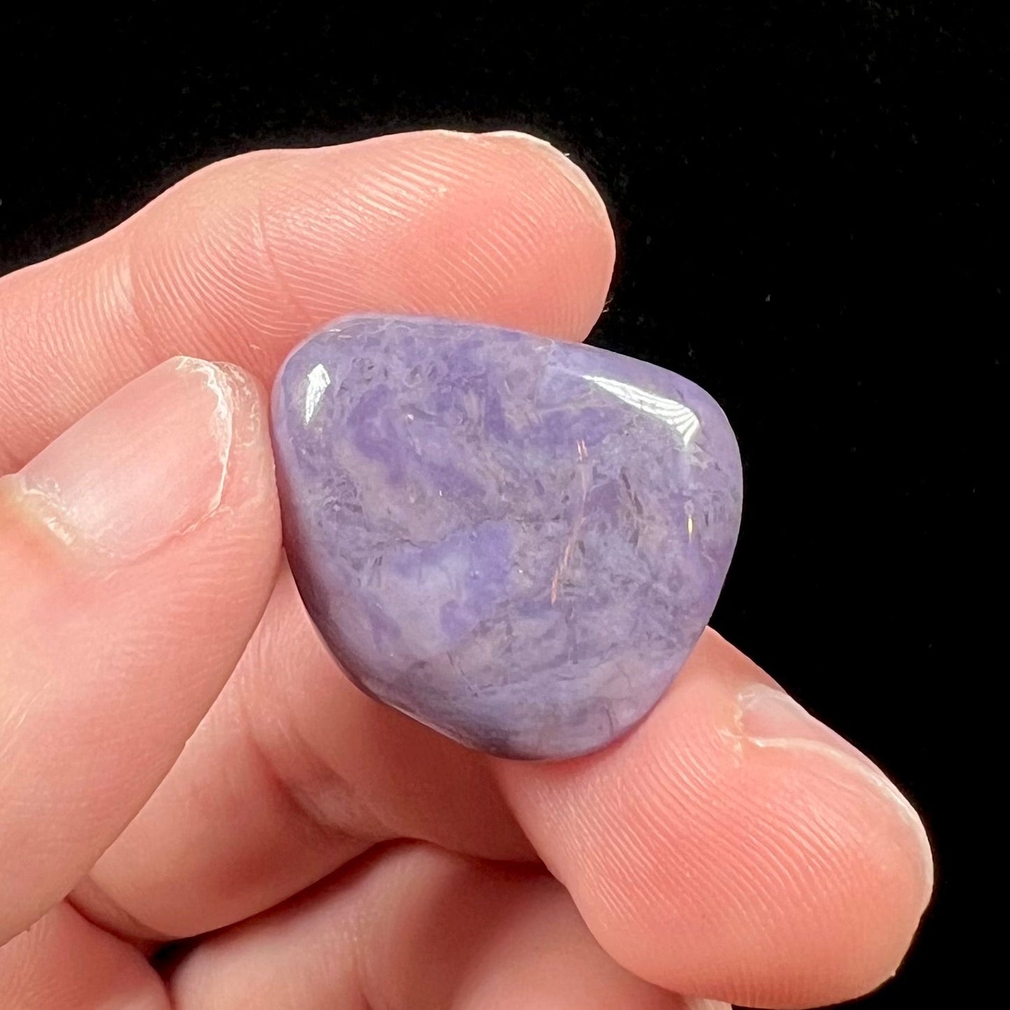 A tumbled Turkish purple jade stone, known as turkiyenite.