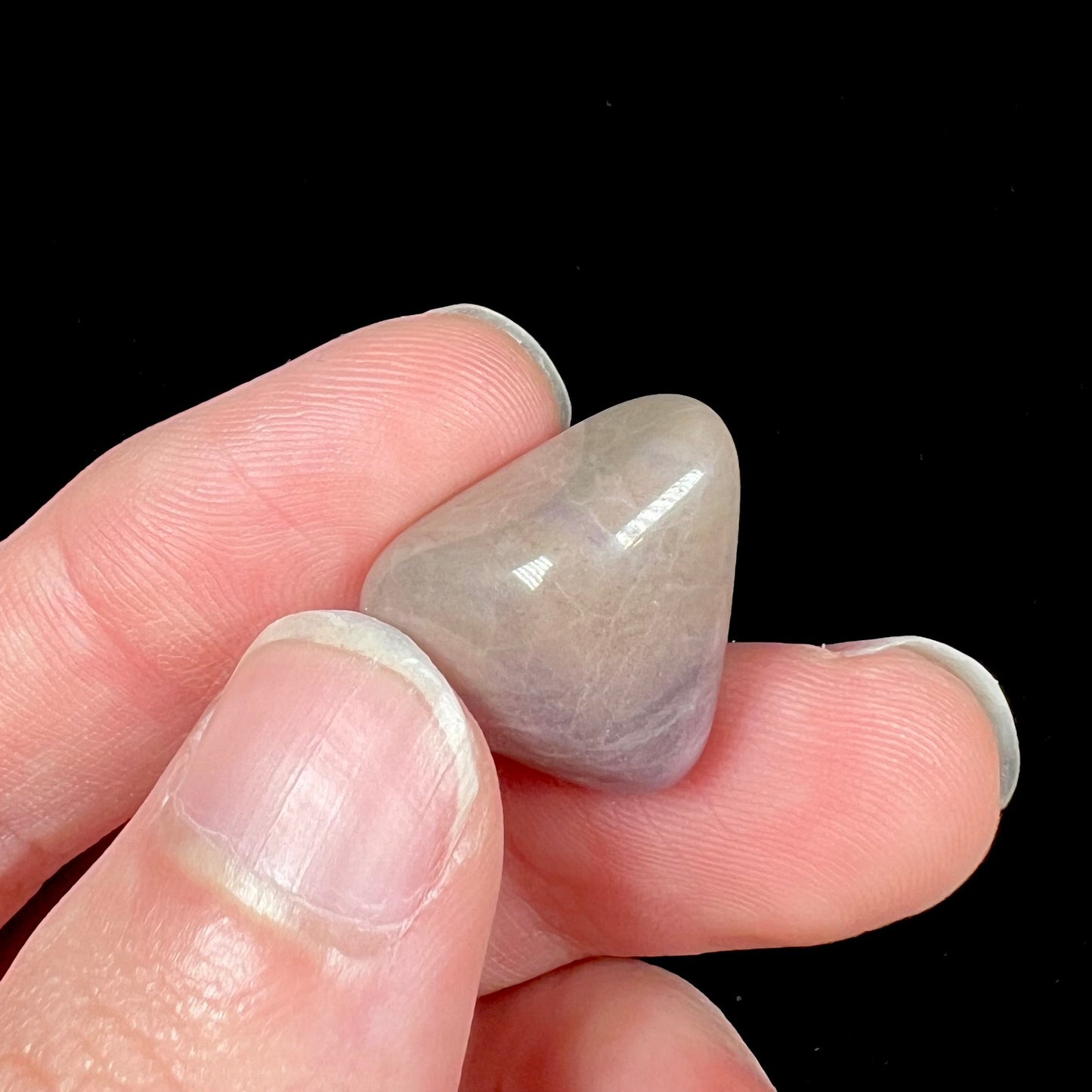 A tumble polished purple and brown turkiyenite jade stone from Bursa, Turkey.