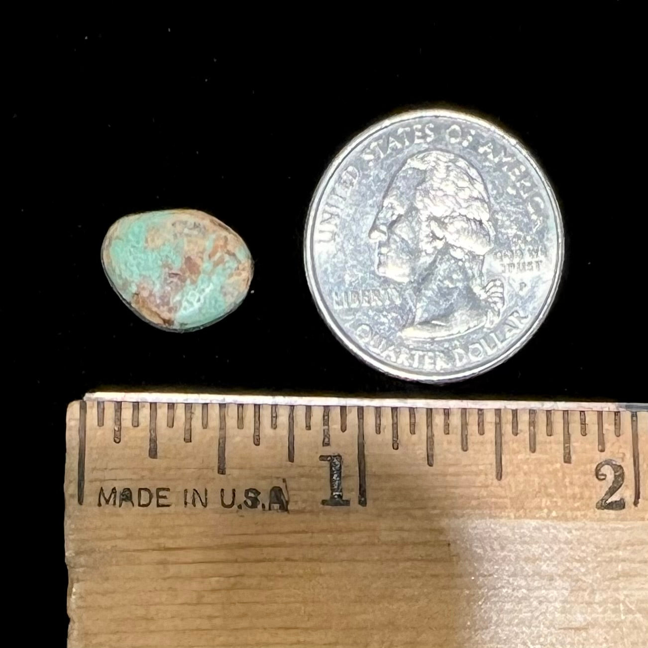 A loose, freeform cabochon cut Royston turquoise stone.  The stone is green with warm, brown matrix.