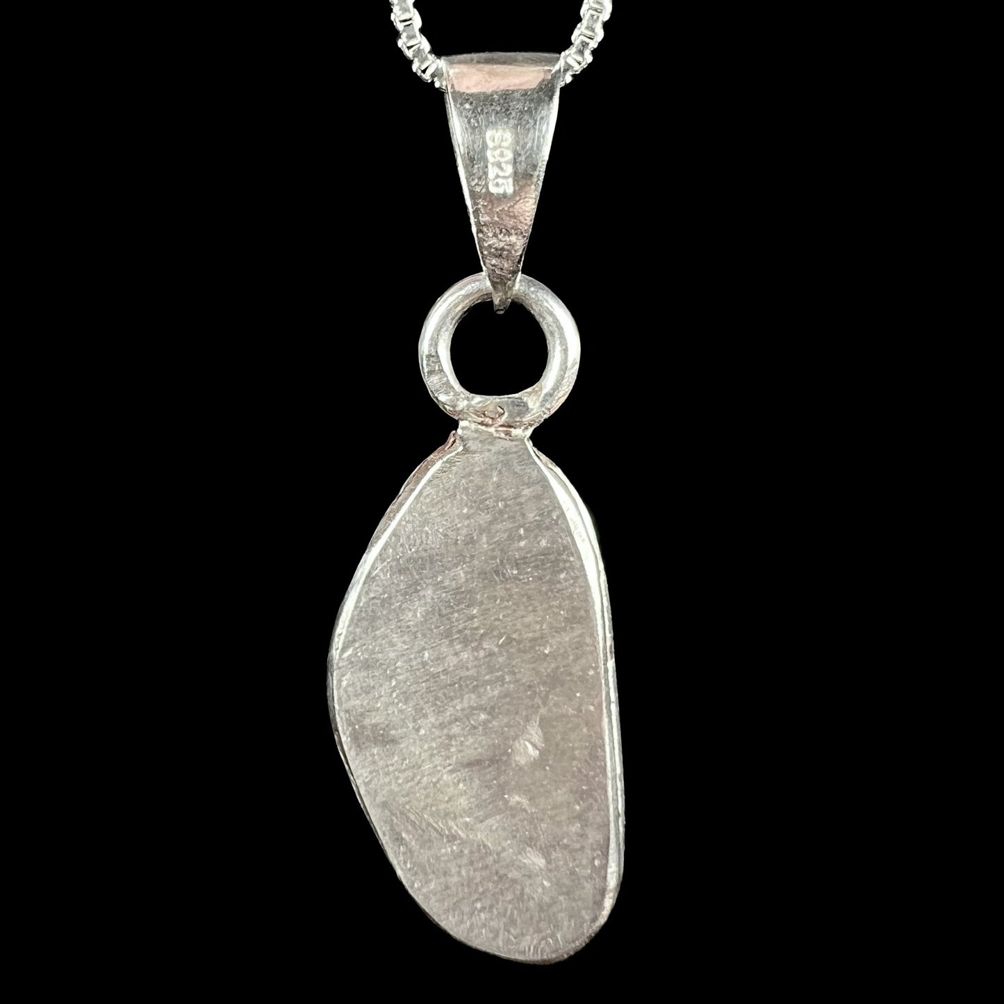 Back side of a sterling silver pendant showing "S925" stamp on bail.  Opal not visible.