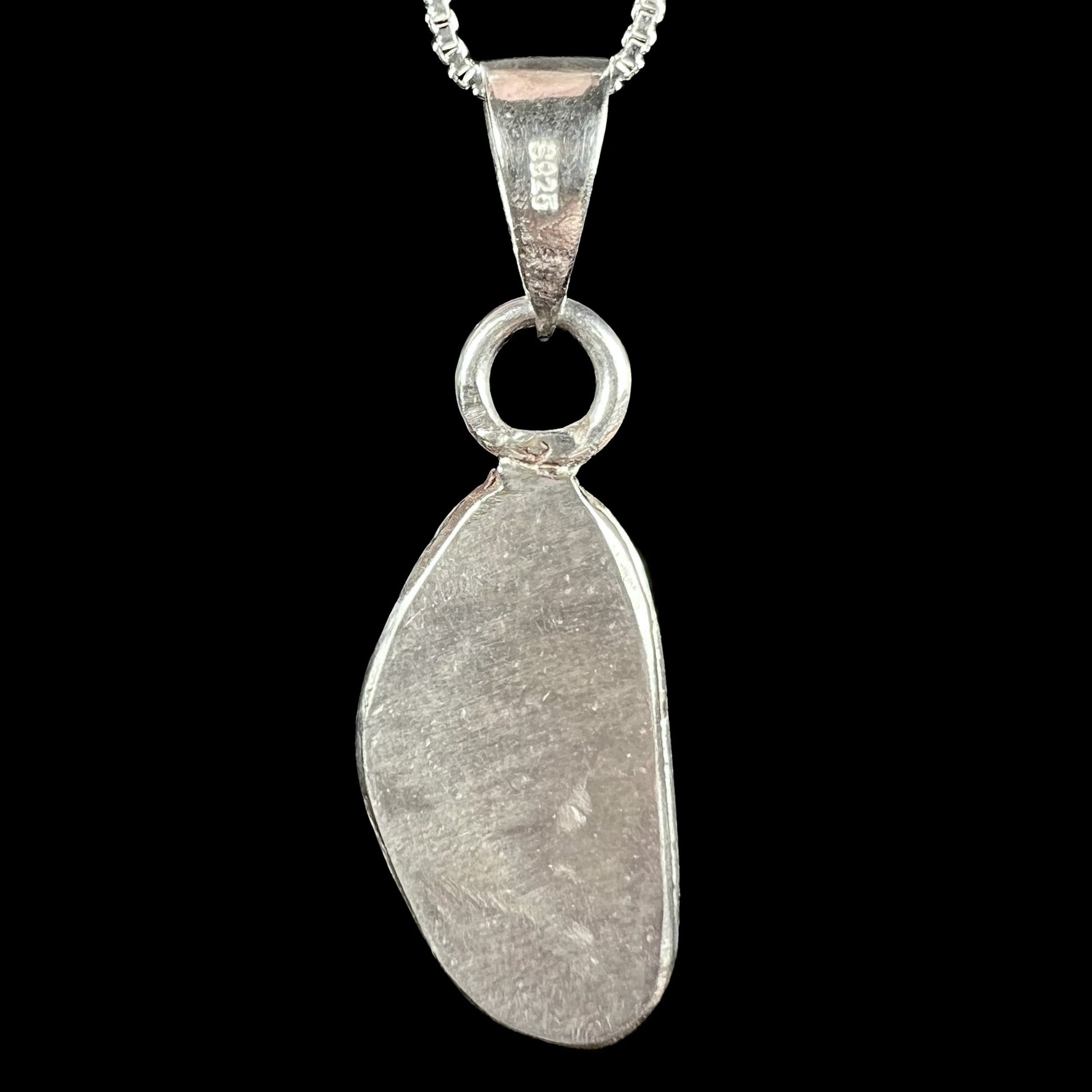 Back side of a sterling silver pendant showing "S925" stamp on bail.  Opal not visible.