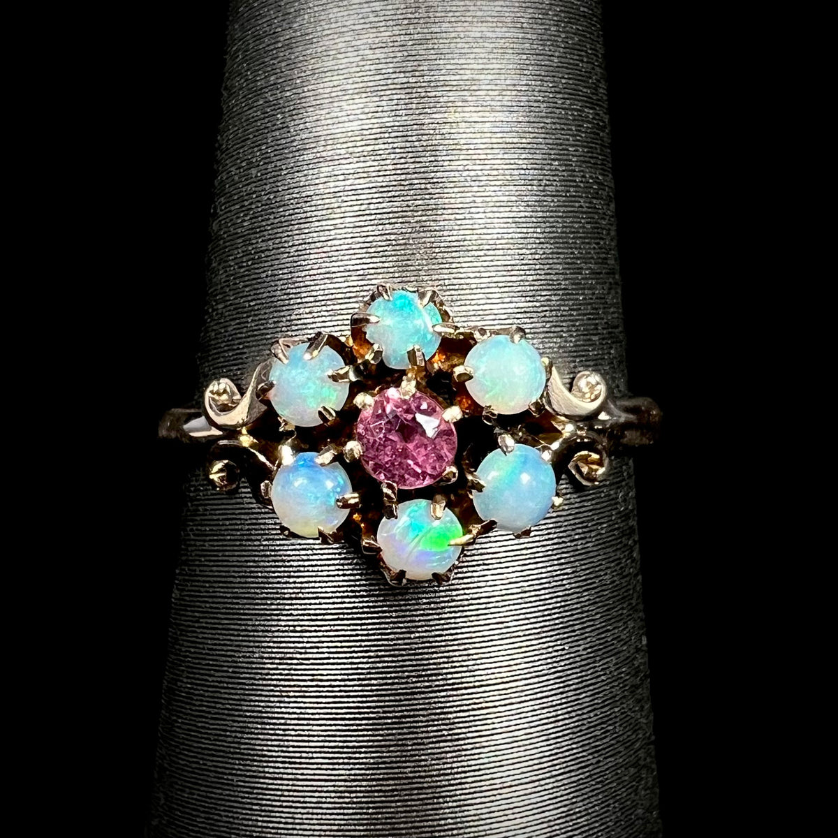 Delicate women's Victorian pink tourmaline and Hungarian opal ring with flower design in 9k gold on display