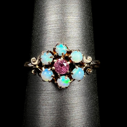 Delicate women's Victorian pink tourmaline and Hungarian opal ring with flower design in 9k gold on display