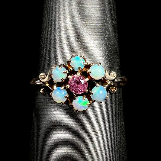 Delicate women's Victorian pink tourmaline and Hungarian opal ring with flower design in 9k gold on display