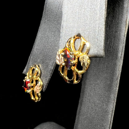 Close-up of vintage Black Hills gold black opal stud earrings on ring display