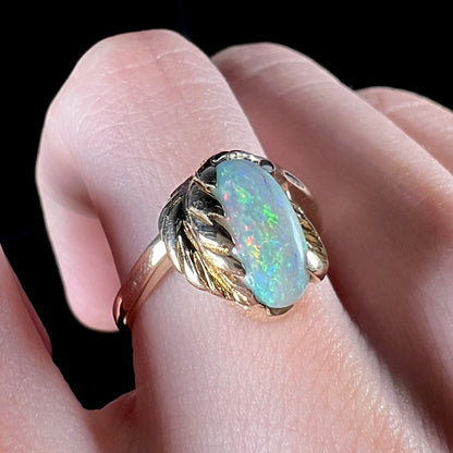 A vintage gold leaf-design ring set with a Coober Pedy opal.