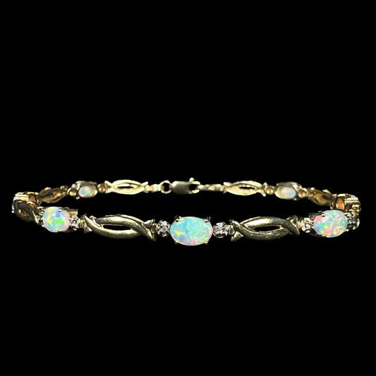 Front view of a vintage 1990s lab-created opal and diamond tennis bracelet in 10k yellow gold with open, modernist style links.