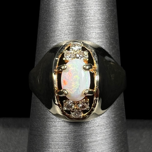 Close-up of vintage c.1960s Mid-Century Modern domed 14k gold Australian opal and diamond ring shown on ring display