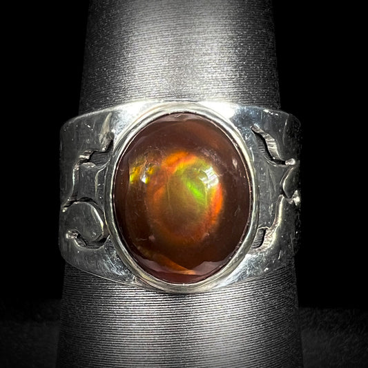 Front close-up of a vintage sterling silver fire agate ring with green and red colors.