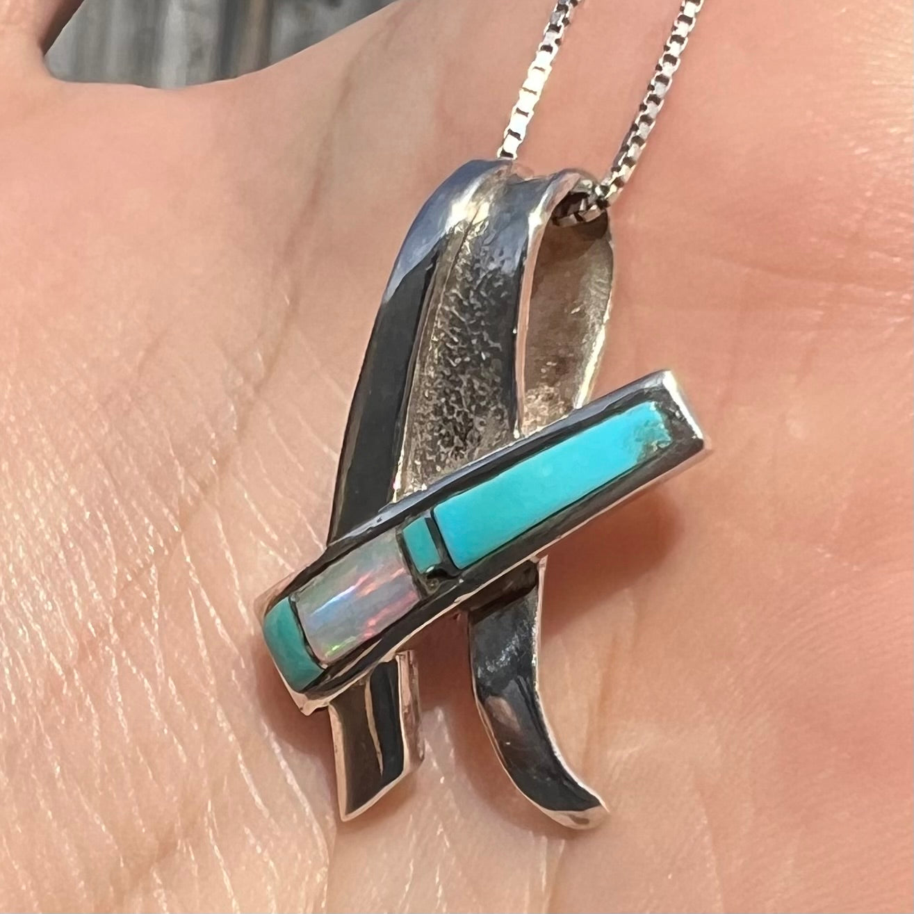 A folded design sterling silver turquoise and lab-created opal inlay necklace.