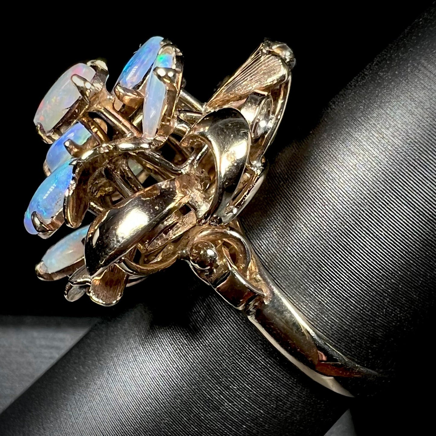 A ladies' vintage, modernist style opal cluster ring in yellow gold.  The ring is tall with a high profile.