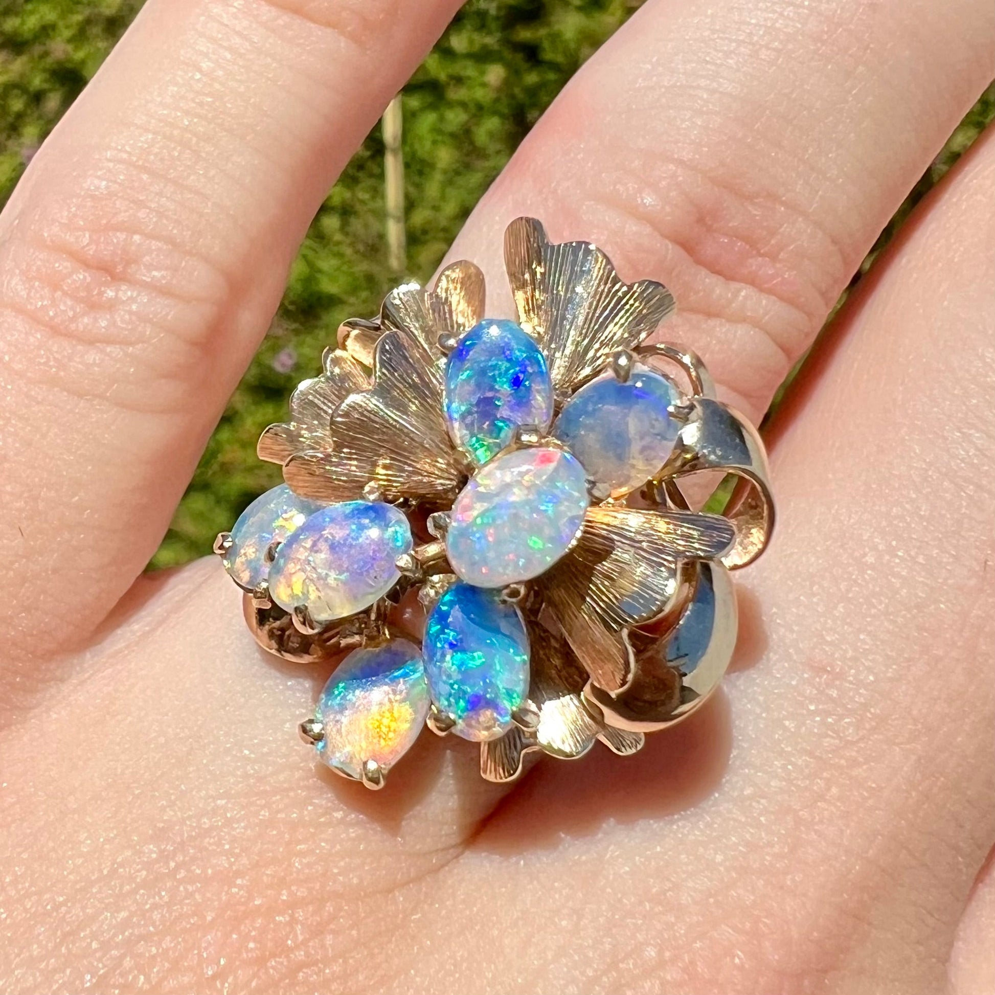 A ladies' vintage, modernist style opal cluster ring in yellow gold.  The ring is tall with a high profile.