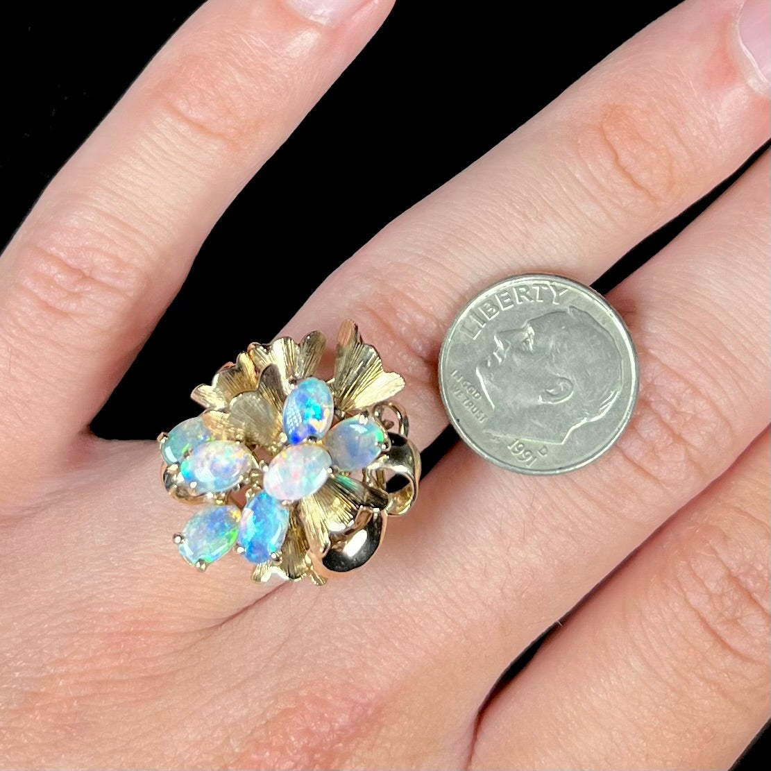 A ladies' vintage, modernist style opal cluster ring in yellow gold.  The ring is tall with a high profile.