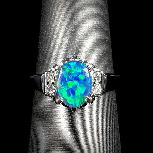 A vivid Lightning Ridge black opal engagement ring in platinum, featuring intense green fire and diamond accents in a delicate Japanese-crafted setting.