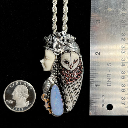 A woman and owl necklace with a nature-inspired motif, made from sterling silver, bone, and an opal doublet.
