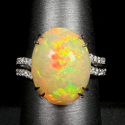 Close-up macro of women's 14k gold Ethiopian opal and diamond cocktail ring with double-prong design on display
