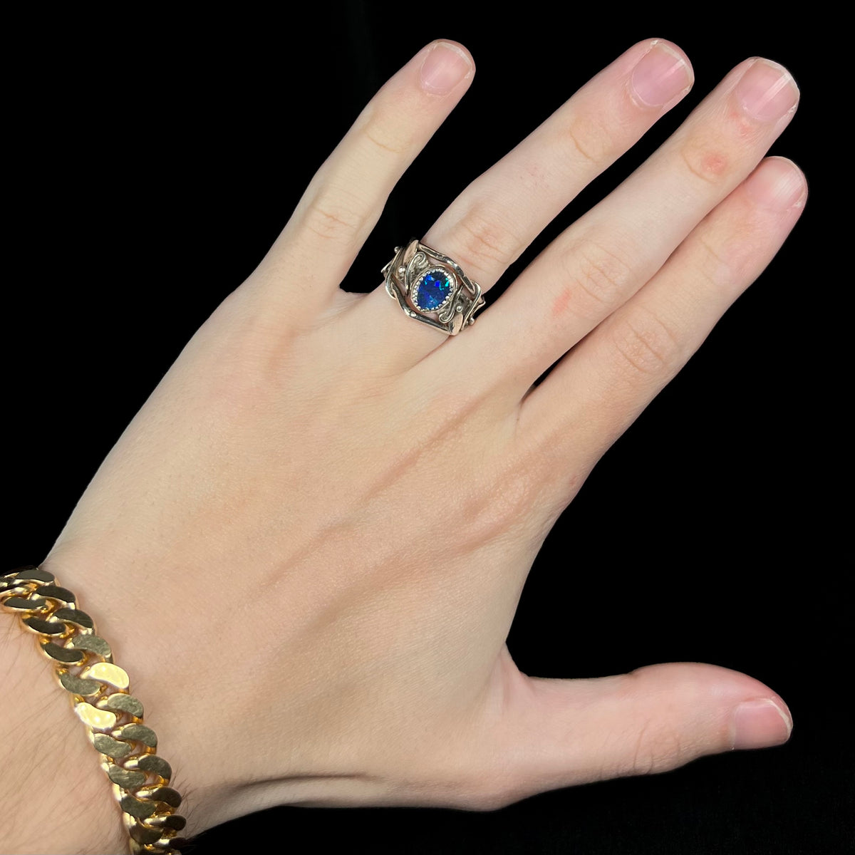 Hand wearing women's handmade nature-inspired silver black opal doublet solitaire ring