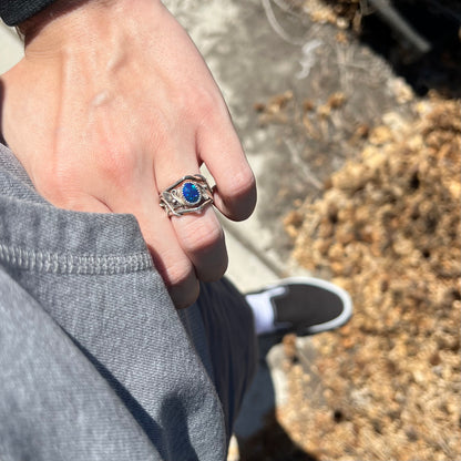 Person's hand resting on hip in natural light wearing women's sterling silver black opal doublet ring