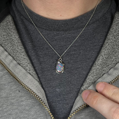 Close-up of person's neck and chest wearing a women's triplet opal necklace made from base metal