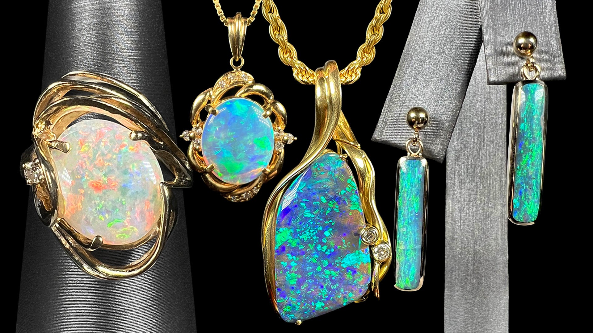 Yellow gold opal jewelry set including white opal ring, a crystal opal pendant and boulder opal necklace, and drop earrings on a black background.